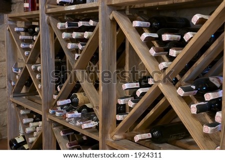 wine bottles laying in wooden rack
