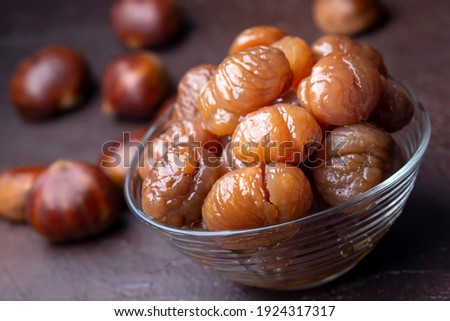 Chestnut dessert and chestnuts on a plate. Traditional delicious Turkish dessert; chestnut candies (Kestane Sekeri) Royalty-Free Stock Photo #1924317317