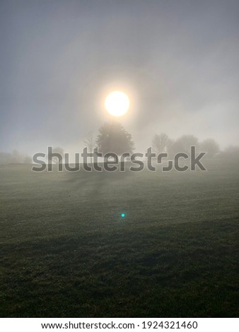 Misty sun across Dunstable Downs Golf Course
