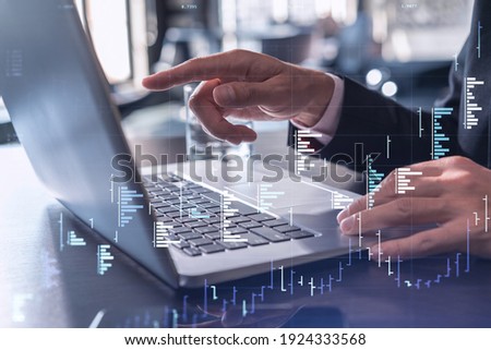 Hands typing the keyboard to research stock market to proceed right investment solutions. Internet trading and wealth management concept. Formal wear. Hologram Forex chart over close up shot.
