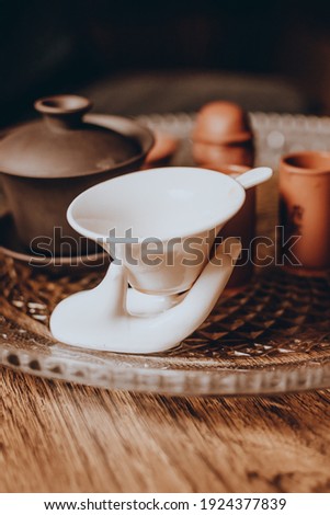 Chinese tea ceremony. Tea Strainer Filter Colander And Guanyin Buddha Hand Style  ,  wood background