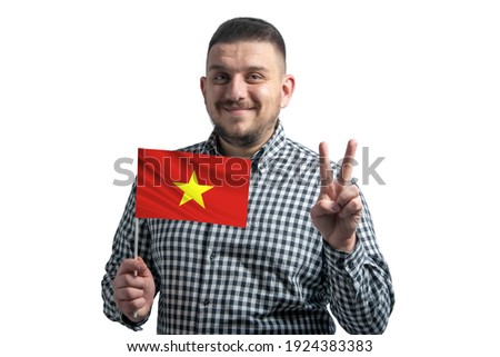 White guy holding a flag of Vietnam and shows two fingers isolated on a white background.