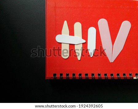 Photo with the letters "HIV" on a red and black background