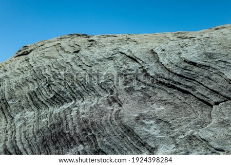 Various rock formations adjoining the coastal line offering for a perfect background for quotes or wallpaper with clear blue skies with. Picture taken from an elevation showing a unique texture