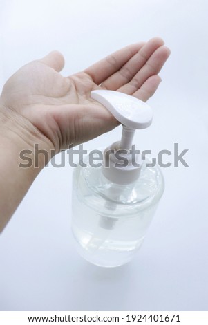 Hand that is squeezing alcohol gel isolated on white background.