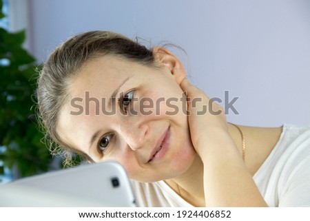young woman communicates via video conference, happy smiles