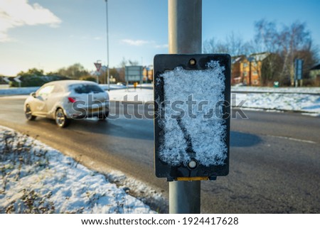 Pedestrian control road crossing winter snow frozen in england uk.