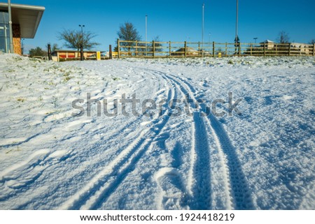 empty pedestrian footpath covered with winter snow in england uk.