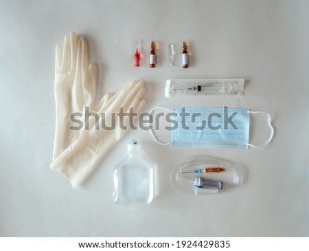 Flat lay with medical items: glaves, mask, syringe, ampoules. Vaccines Used for prevention, immunity and treatment from covid-19 infection or coronavirus. Concepts of disease prevention.