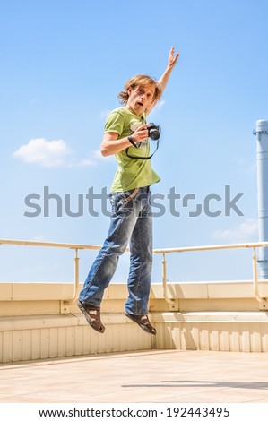 crazy cheerful photographer in jump