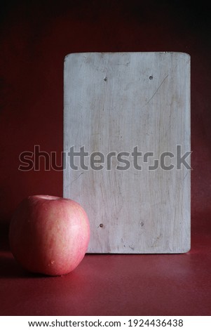 Single Fuji apple isolated on red background