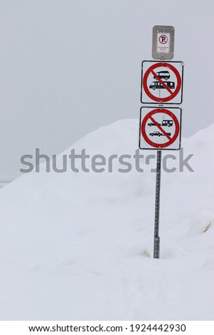 white road sign with red circle prohibiting the recreational vehicle, car with trailer to park