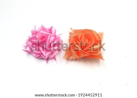 Roses are made from ribbons folded back and forth for a ceremony souvenir. Inside can contain coin.