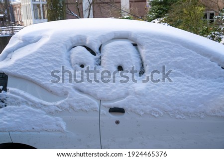 Car with snow and a funny face
