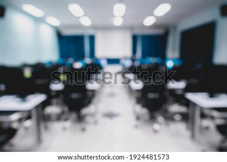 Blur and defocus of lecture or class room in the university which have white screen for presentation, conference as modern education