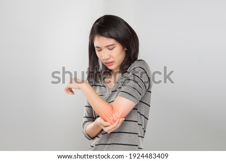 young asian woman feel elbow bones injury