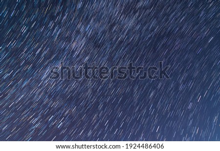 Beautiful starry sky with star trails. Space background. Abstract long exposure background.