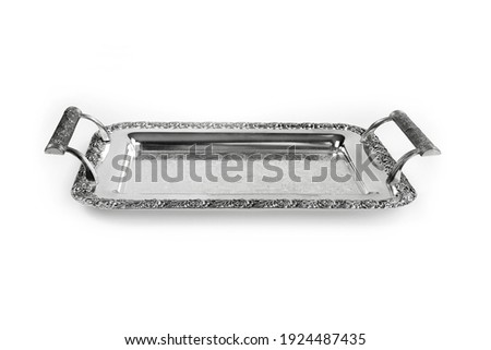 Antique silver tray with handles. Old luxury tray isolated on white background with clipping path. Closeup, front view. Royalty-Free Stock Photo #1924487435