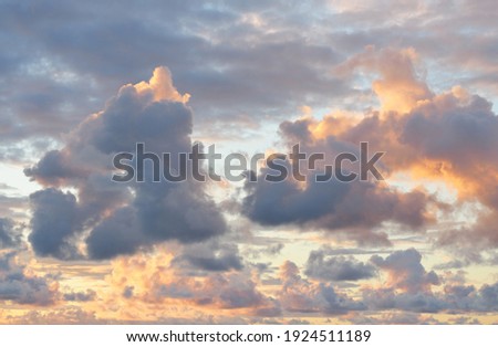Epic sunset sky, colorful glowing clouds after thunderstorm. Golden evening sunlight. Dramatic cloudscape. Concept art, meteorology, ecology, climate change, religion, hope, heaven, graphic resources