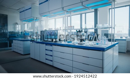 Modern Medical Research Laboratory with Computer, Microscope, Glassware with Biochemicals on the Desk. Scientific Lab Biotechnology Development Center Full of High-Tech Equipment. Royalty-Free Stock Photo #1924512422
