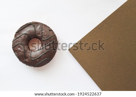 brown donut on a white sheet. isolated. postcard. bakery products
