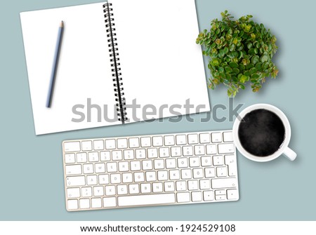 top view work desk template with computer keyboard, spiral notepad with copy space, pencil, coffee mug and potted plant