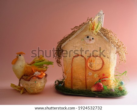 House and rooster on a pink background