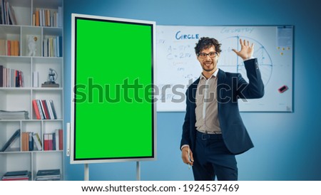 Portrait of Friendly Teacher Explains Lesson to a Classroom, Uses Green Screen Digital Whiteboard. Successful Businessman Talks about Project Growth Uses Chroma Key Digital Blackboard