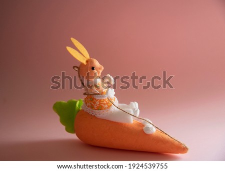 Rabbit that manages a flying carrot on pink background