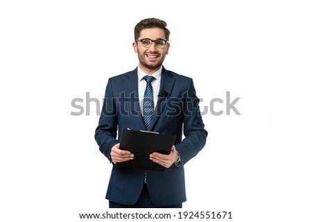 positive broadcaster in eyeglasses looking at camera while holding clipboard isolated on white Royalty-Free Stock Photo #1924551671