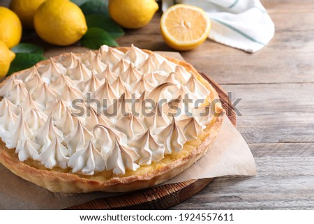 Delicious lemon meringue pie on wooden table