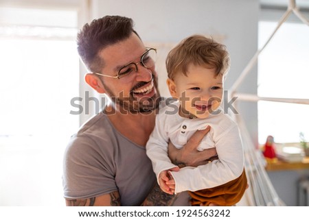 Father and baby son having fun together at home Royalty-Free Stock Photo #1924563242