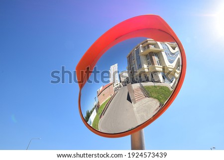 modern buildings reflected in a convex  traffic mirror Royalty-Free Stock Photo #1924573439