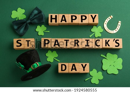 Words Happy St. Patrick's day and festive decor on green background, flat lay