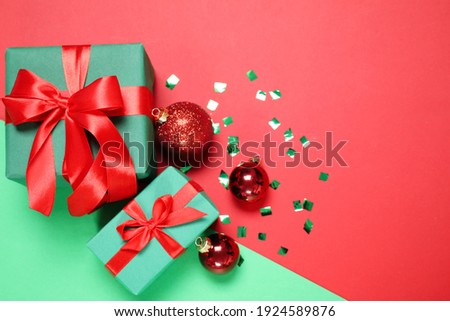 Gift boxes and Christmas decorations on color background, flat lay. Space for text
