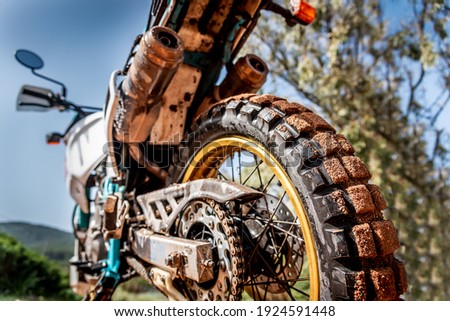 Rear view of a dirt bike in the mud