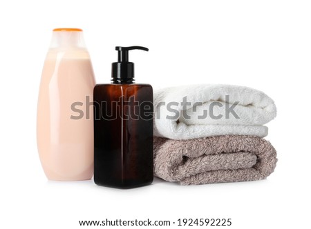 Personal hygiene products and towels on white background