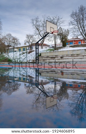 Basketball court reflection in rain water