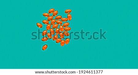 Close up of capsules Omega 3 on blue background. Top view, high resolution product. Health care concept.