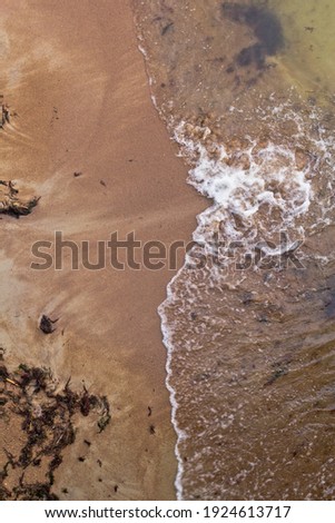Sandy beach and waves. View from above.