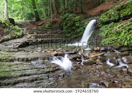 Nature landscape with beautiful cascade waterfall  Krutylo in mountain gorge on Turichka river near Lumshory village of TransCarpathia, Carpathians. Ukraine.
