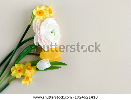 Yellow tulips bouquet on a beige background. Flat lay, top view. Concept of holiday, birthday, Easter, womens day