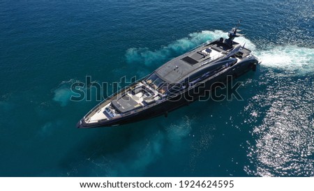 Aerial drone top view photo of latest technology modern yacht speeding in Mediterranean port with deep blue sea