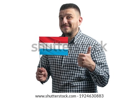 White guy holding a flag of Luxembourg and shows the class by hand isolated on a white background. Like for Luxembourg.