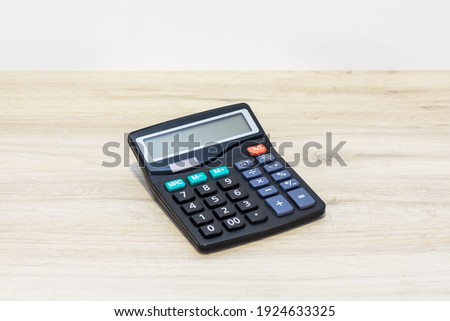Black calculating calculator on the office table. Calculator for calculating the balance in accounting.