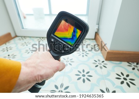 thermal imaging camera inspection of window building. check heat loss Royalty-Free Stock Photo #1924635365