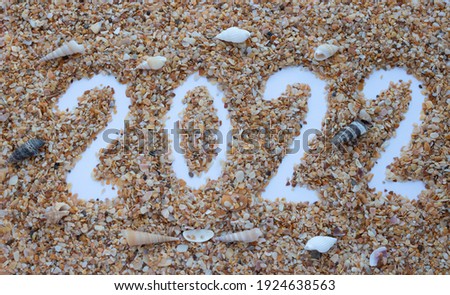 The number 2022 is drawn on the sand of shells.New Year's Calendar.