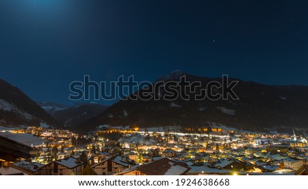 Night long exposure panorama of the city of Moena in italian dolomites in Val di Fassa region during winter time.