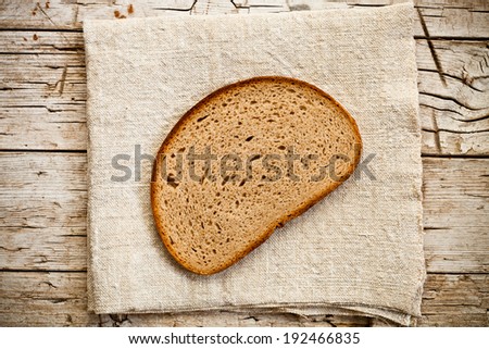 slice of rye bread on rustic wooden background 