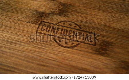 Confidential stamp printed on wooden box. Government, top secret, business and non public document concept.
